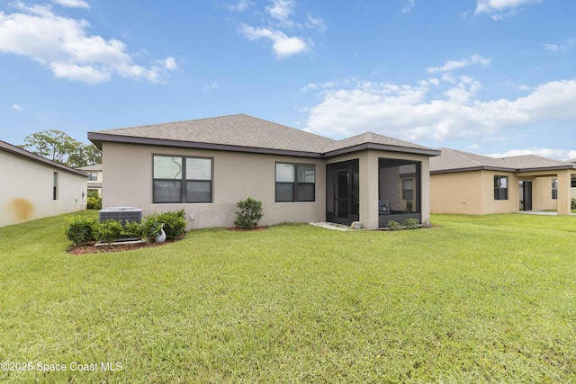 1669 Mineral Loop Dr NW, Palm Bay, FL 32907 - rear view of property with stucco siding, roof with shingles, a lawn, and a sunroom