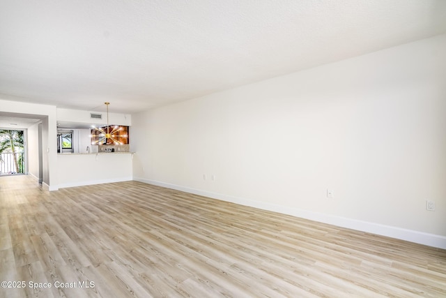 8496 Ridgewood Ave Unit 3205, Cape Canaveral, FL 32920 - unfurnished living room with light wood-style floors and baseboards