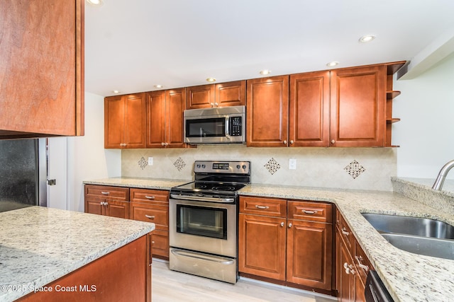 8496 Ridgewood Ave Unit 3205, Cape Canaveral, FL 32920 - kitchen with appliances with stainless steel finishes, light stone countertops, recessed lighting, open shelves, and light wood finished floors