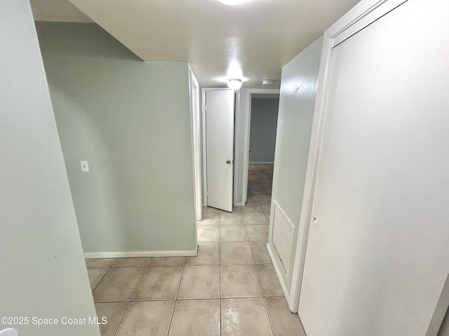 176 San Juan Cir, Melbourne, FL 32935 - corridor featuring light tile patterned floors and baseboards