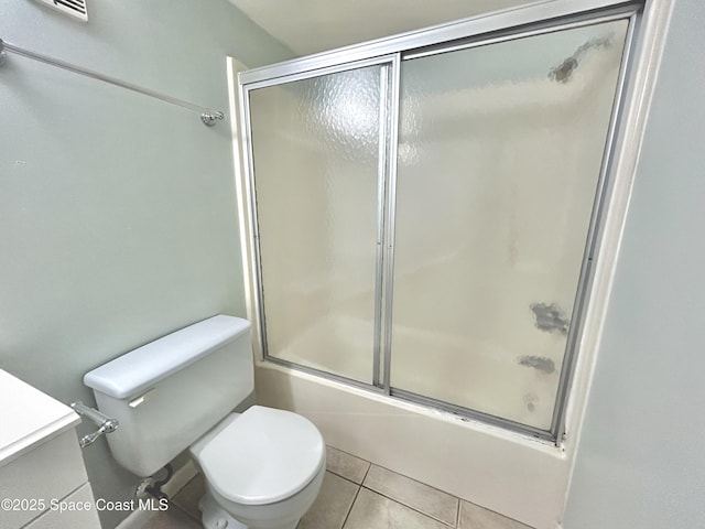 176 San Juan Cir, Melbourne, FL 32935 - bathroom featuring bath / shower combo with glass door, vanity, and tile patterned flooring