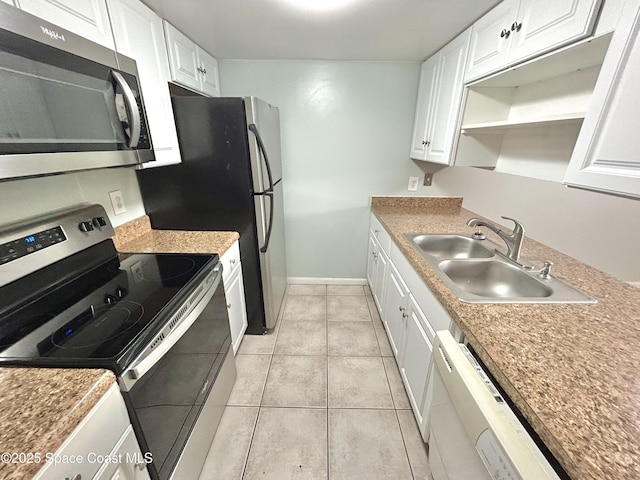 176 San Juan Cir, Melbourne, FL 32935 - kitchen featuring stainless steel appliances, white cabinetry, and light tile patterned floors
