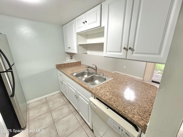176 San Juan Cir, Melbourne, FL 32935 - kitchen featuring fridge, dishwasher, white cabinetry, and light tile patterned flooring