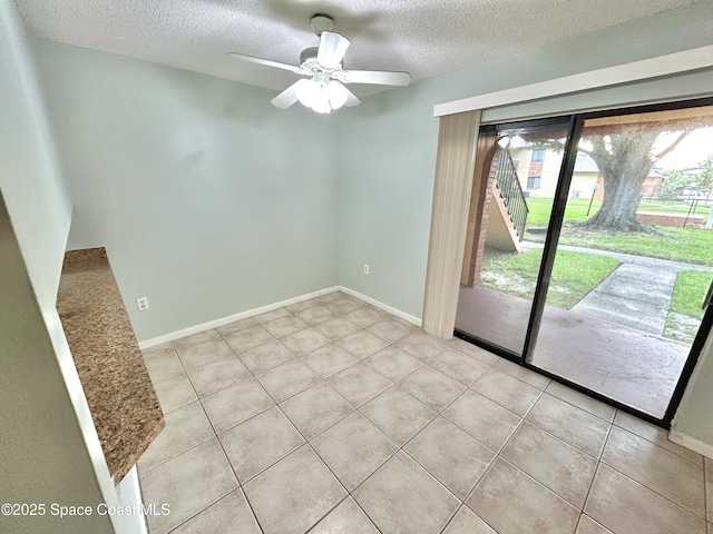 176 San Juan Cir, Melbourne, FL 32935 - spare room with a textured ceiling, light tile patterned floors, and ceiling fan