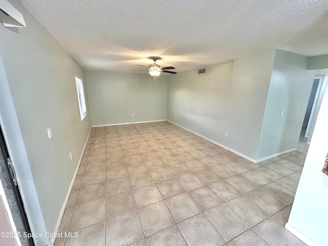 176 San Juan Cir, Melbourne, FL 32935 - empty room with a textured ceiling, ceiling fan, and light tile patterned floors
