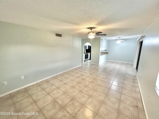 176 San Juan Cir, Melbourne, FL 32935 - empty room with ceiling fan, arched walkways, light tile patterned floors, and a textured ceiling