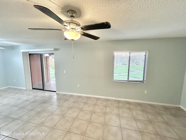 176 San Juan Cir, Melbourne, FL 32935 - spare room featuring plenty of natural light, a textured ceiling, ceiling fan, and light tile patterned floors