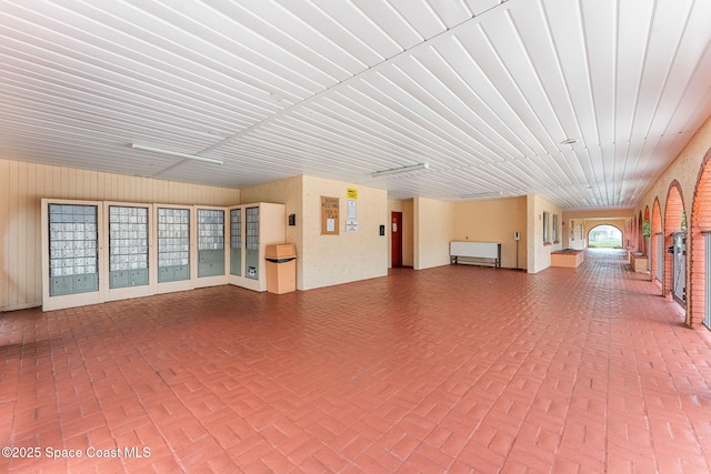 176 San Juan Cir, Melbourne, FL 32935 - unfurnished living room with brick patterned flooring