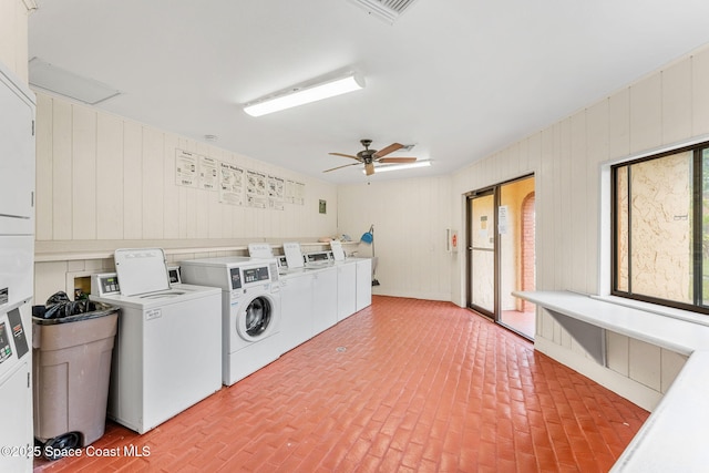 176 San Juan Cir, Melbourne, FL 32935 - communal laundry room featuring washer and clothes dryer, brick floors, a ceiling fan, and wooden walls
