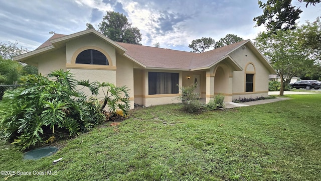 4445 Seneca Ave, Cocoa, FL 32926 - view of front of home with stucco siding and a front yard