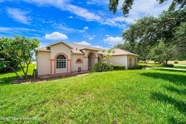 3912 Snowy Egret Dr, Melbourne, FL 32904 - mediterranean / spanish-style home with stucco siding and a front lawn
