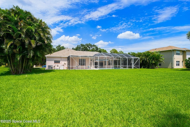 3912 Snowy Egret Dr, Melbourne, FL 32904 - back of house with a lawn, a lanai, and stucco siding