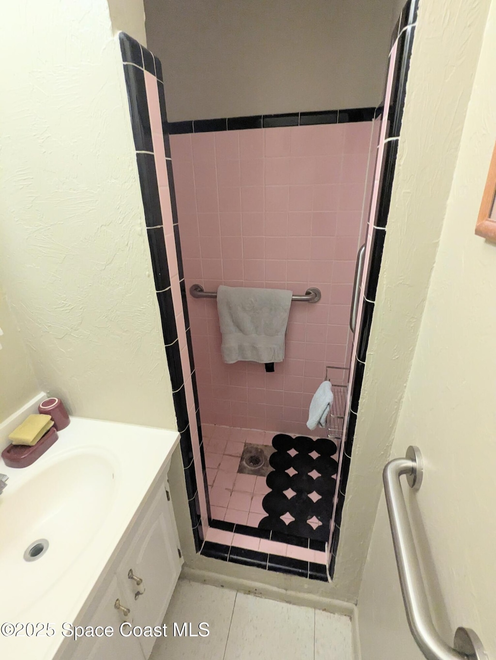213 Lagrange Ave, Titusville, FL 32796 - full bathroom featuring a stall shower, vanity, and a textured wall