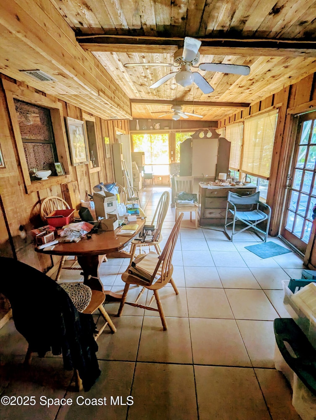 213 Lagrange Ave, Titusville, FL 32796 - dining space with wooden ceiling, wooden walls, a ceiling fan, and tile patterned flooring