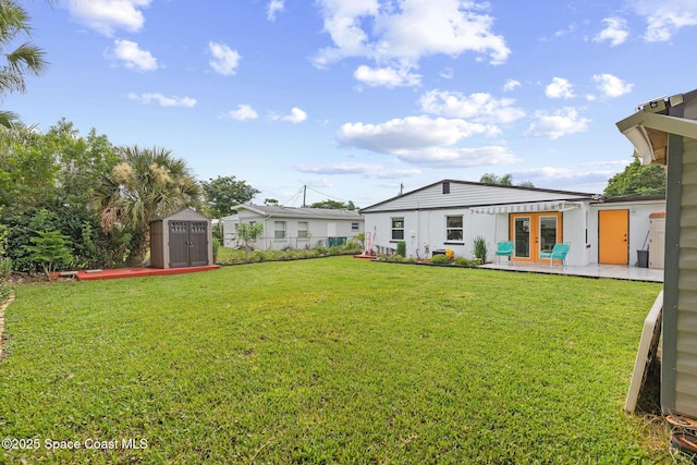 312 Tulip Ln, Melbourne, FL 32901 - view of yard featuring french doors and a storage unit