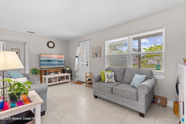 312 Tulip Ln, Melbourne, FL 32901 - living room featuring light tile patterned floors and baseboards