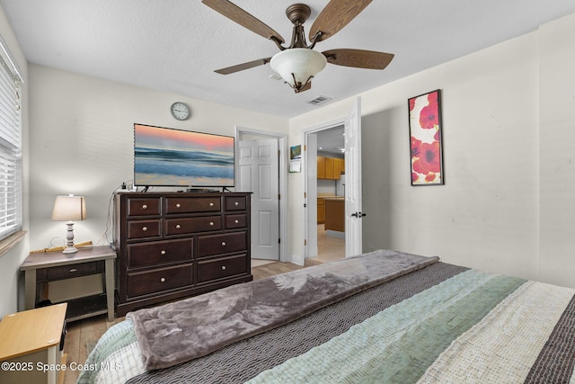 312 Tulip Ln, Melbourne, FL 32901 - bedroom with light wood-style flooring and a ceiling fan