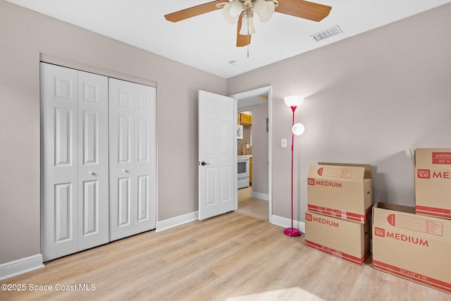 312 Tulip Ln, Melbourne, FL 32901 - unfurnished bedroom featuring wood finished floors, a closet, and ceiling fan