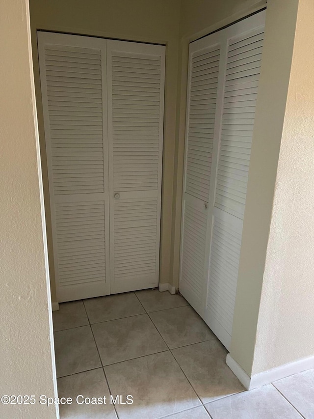 725 Port Malabar Blvd NE, Palm Bay, FL 32905 - hallway with light tile patterned flooring and baseboards
