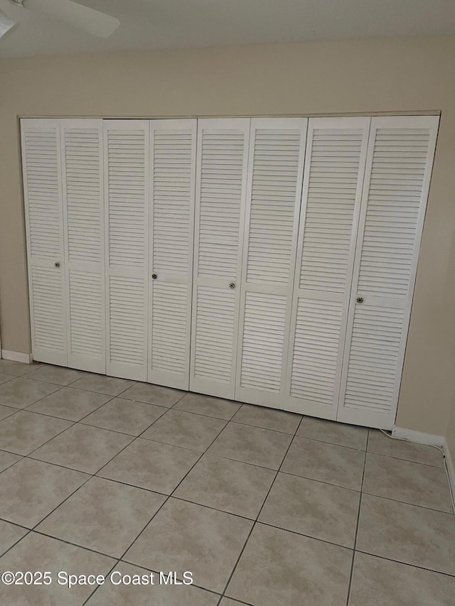725 Port Malabar Blvd NE, Palm Bay, FL 32905 - unfurnished bedroom with light tile patterned floors and a closet
