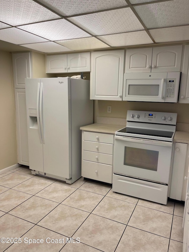 725 Port Malabar Blvd NE, Palm Bay, FL 32905 - kitchen featuring white appliances, light countertops, light tile patterned flooring, and a drop ceiling