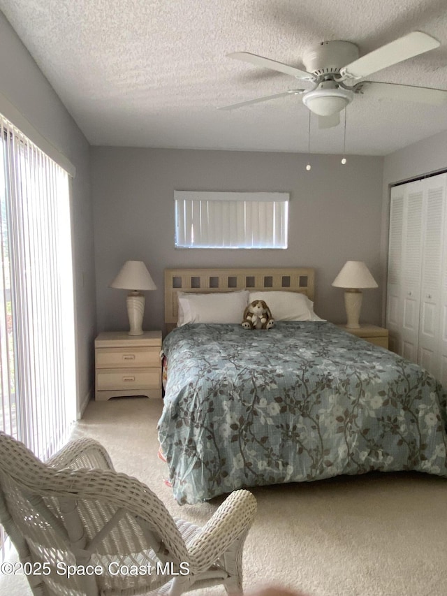 3343 Sandy Reef Ct, Melbourne Beach, FL 32951 - carpeted bedroom with a closet, a textured ceiling, and ceiling fan