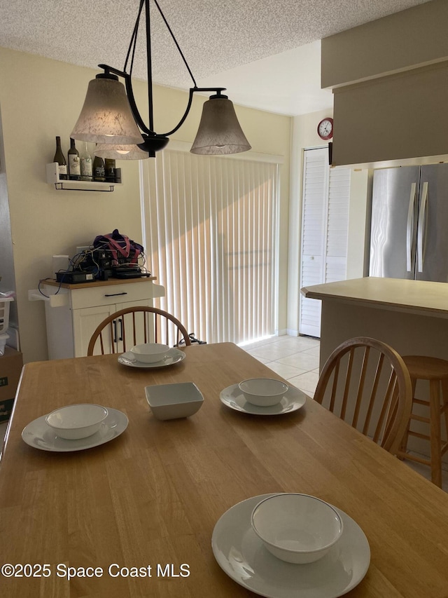 3343 Sandy Reef Ct, Melbourne Beach, FL 32951 - dining space featuring a textured ceiling and light tile patterned floors