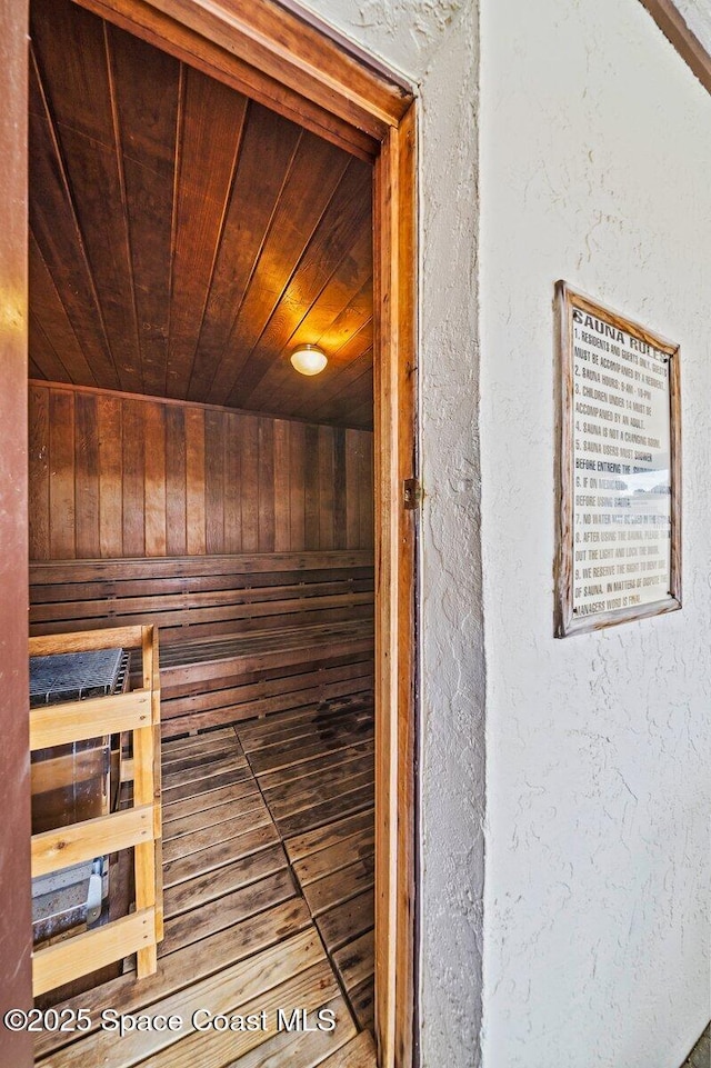 3343 Sandy Reef Ct, Melbourne Beach, FL 32951 - sauna with wooden ceiling, wooden walls, and a textured wall