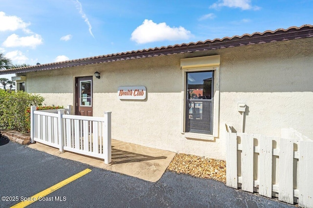 3343 Sandy Reef Ct, Melbourne Beach, FL 32951 - doorway to property with stucco siding