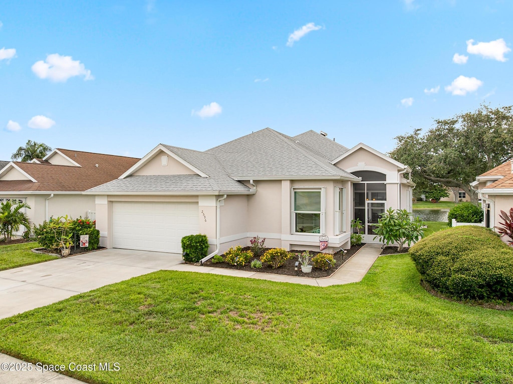 2596 Addington Cir, Rockledge, FL 32955 - view of front of property with a garage, stucco siding, concrete driveway, a front lawn, and roof with shingles