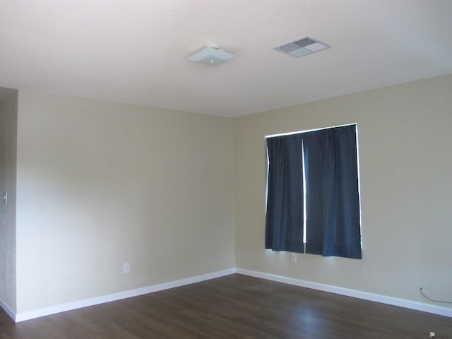 empty room featuring dark hardwood / wood-style flooring