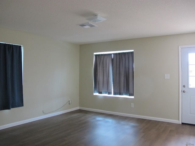 entryway featuring dark hardwood / wood-style floors and a textured ceiling