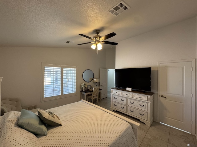 tiled bedroom featuring a textured ceiling, visible vents, and a ceiling fan