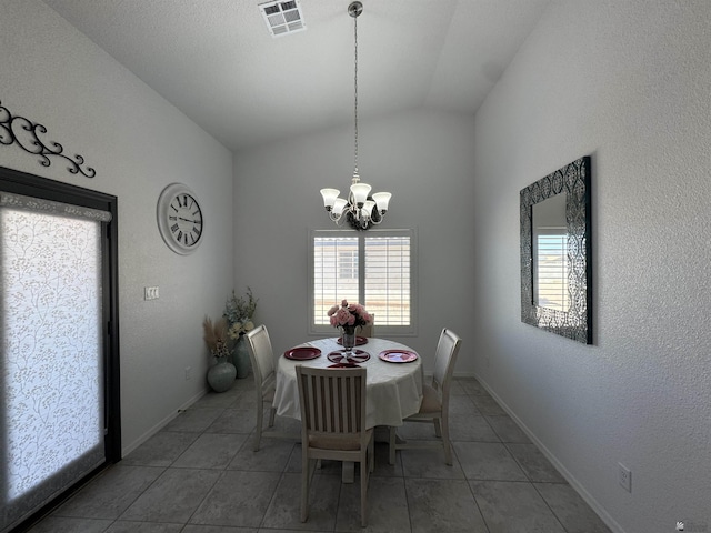 unfurnished dining area with lofted ceiling, a chandelier, tile patterned flooring, visible vents, and baseboards