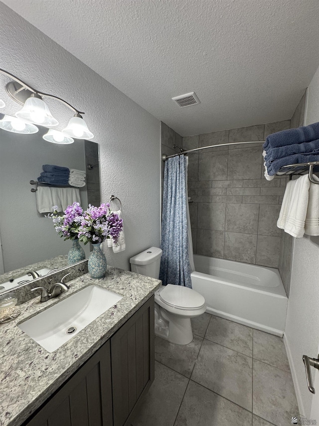 bathroom with visible vents, a textured wall, a textured ceiling, and toilet