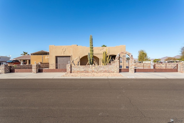 pueblo revival-style home with a garage