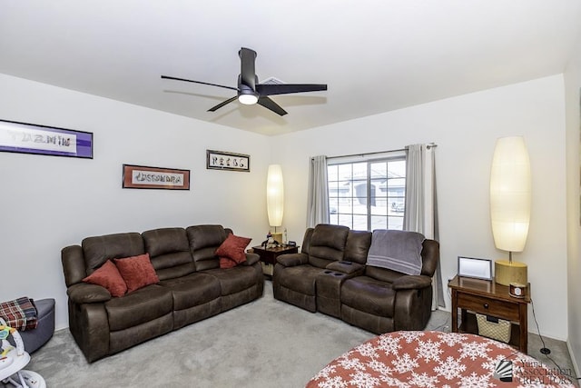 living room featuring carpet floors and a ceiling fan