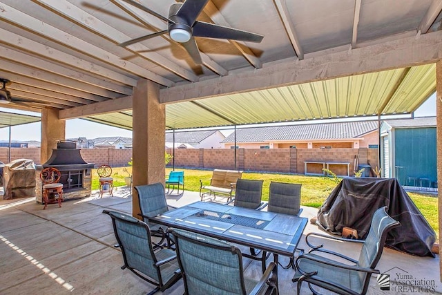 view of patio with ceiling fan, outdoor dining area, area for grilling, and a fenced backyard