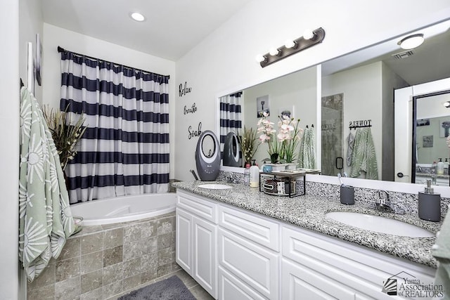 full bath featuring double vanity, tiled shower, a relaxing tiled tub, and a sink