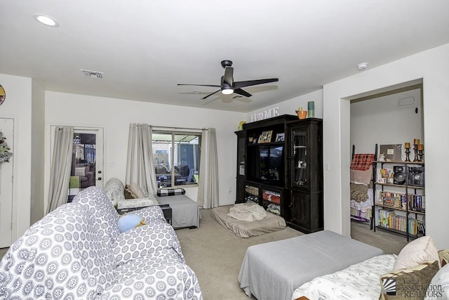 carpeted bedroom featuring access to exterior, ceiling fan, and visible vents