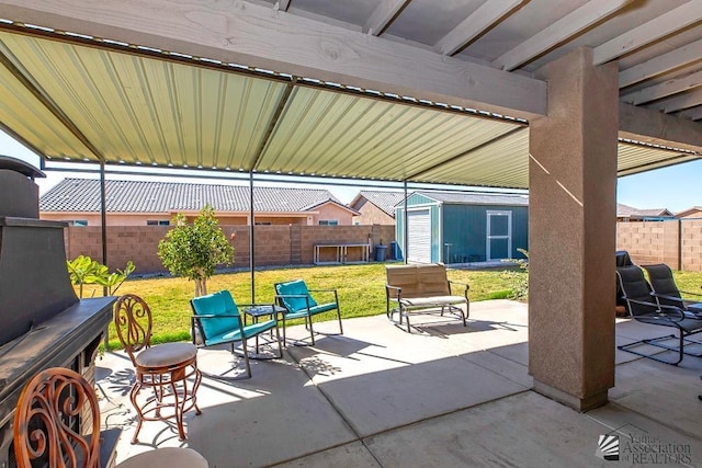 view of patio with a storage shed, an outdoor structure, and a fenced backyard