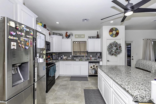 kitchen featuring visible vents, backsplash, a sink, light stone countertops, and black appliances