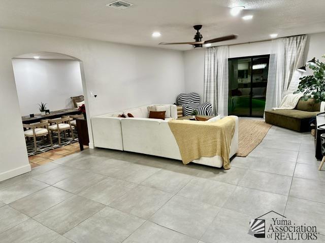 living room with light tile patterned flooring and ceiling fan