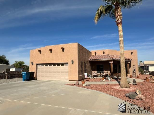 pueblo revival-style home with a garage