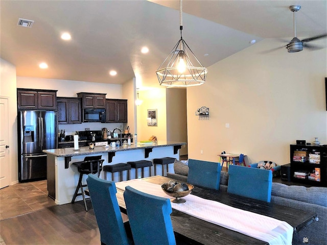 dining space featuring dark wood-type flooring and sink