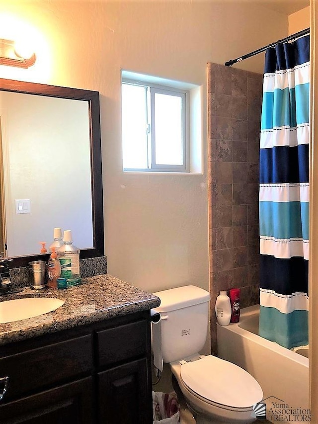 full bathroom with vanity, toilet, and shower / tub combo