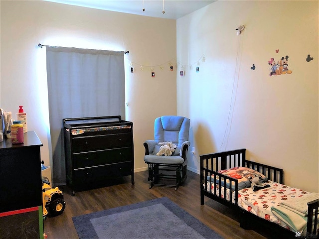 bedroom with dark hardwood / wood-style floors