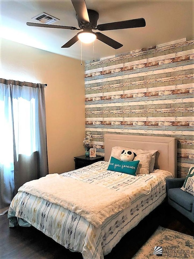 bedroom featuring hardwood / wood-style floors and ceiling fan