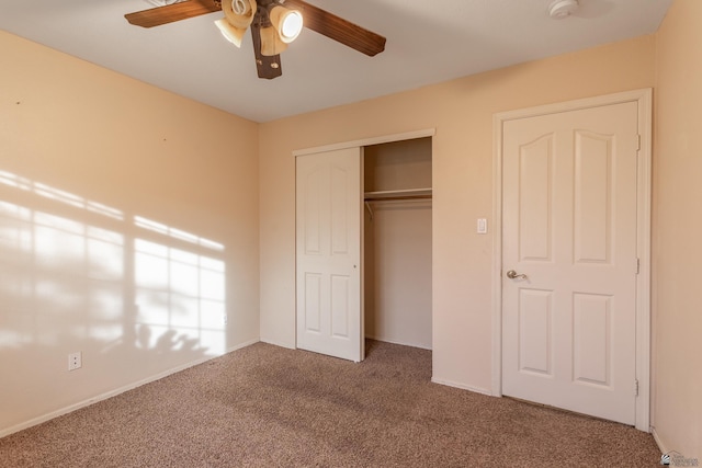 unfurnished bedroom featuring ceiling fan, a closet, and carpet floors