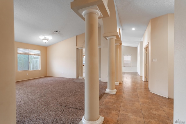 unfurnished room featuring light tile patterned floors and a textured ceiling